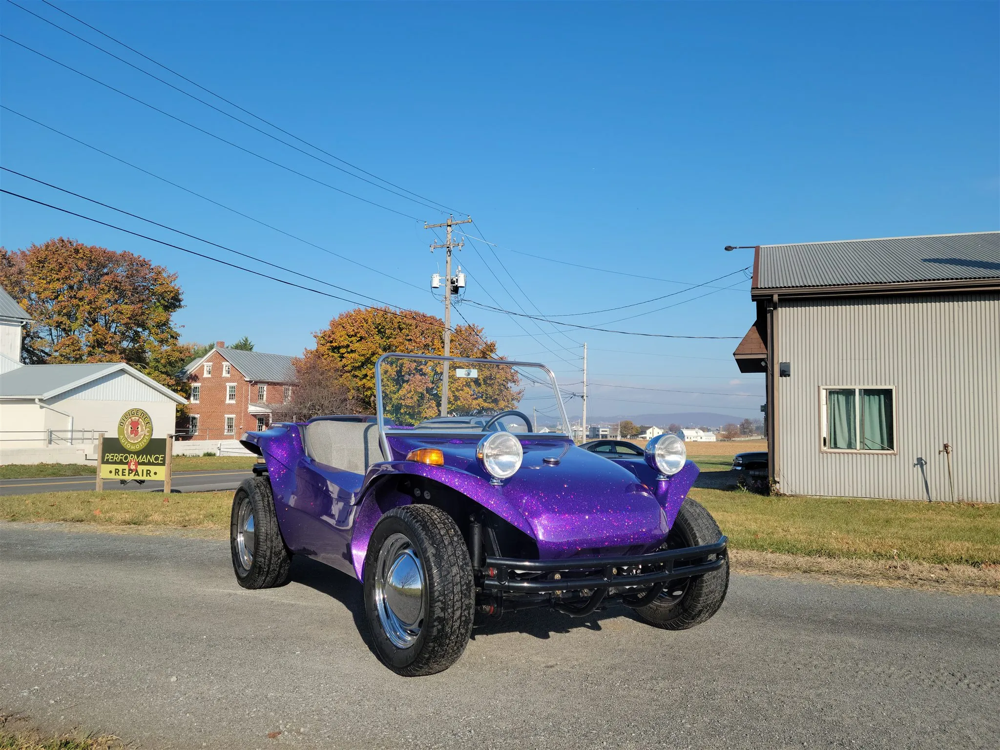 A purple 1963 VW dune buggy parked on a country road
